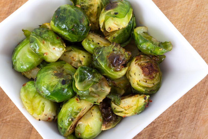 A bowl of cooked brussels sprouts.