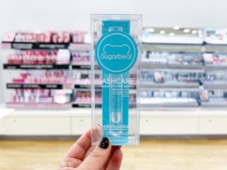 Hand holding box of Sugarbear Lash Serum