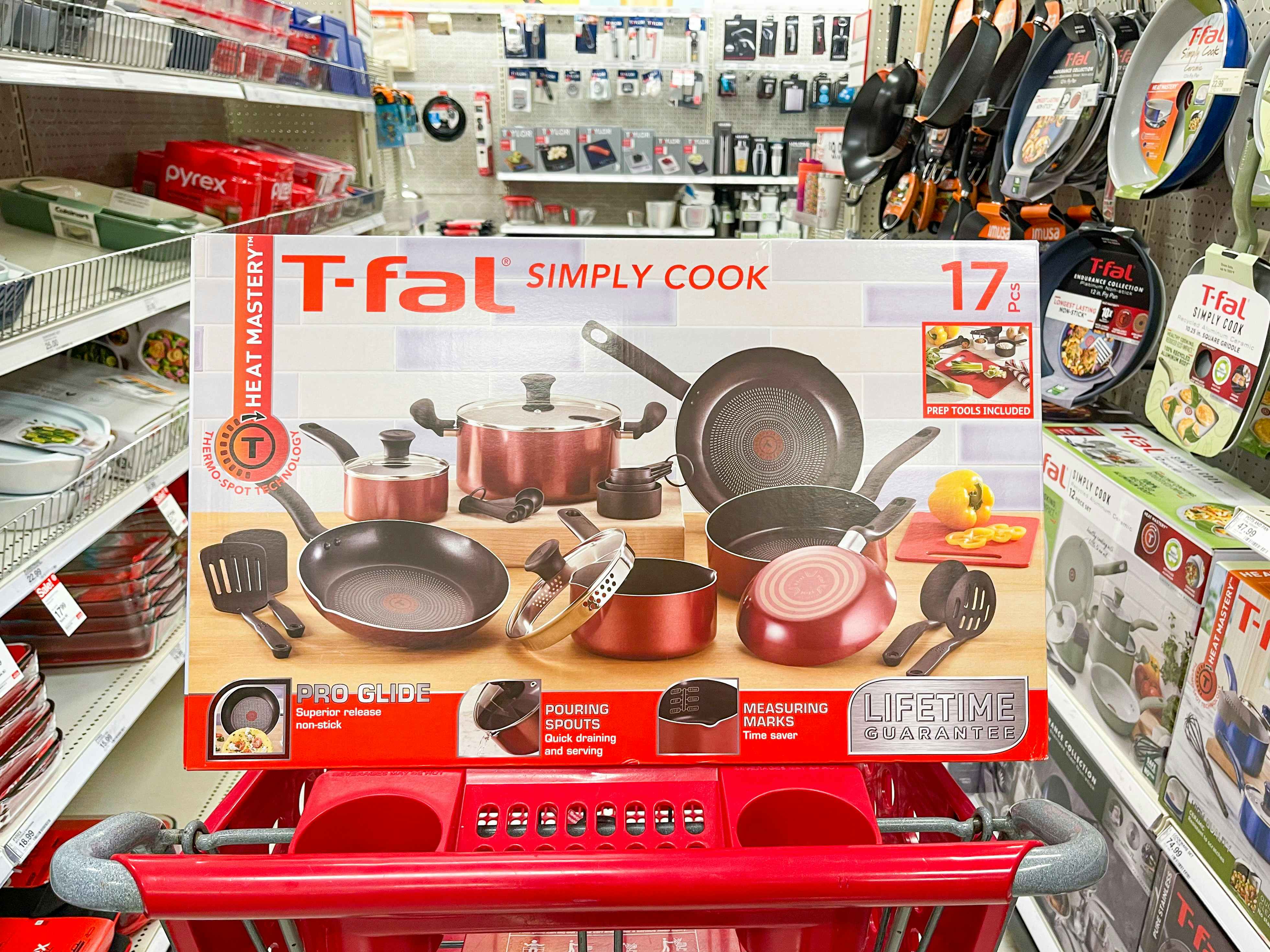 A box of T-Fal Simply Cook cookware sitting in a cart.
