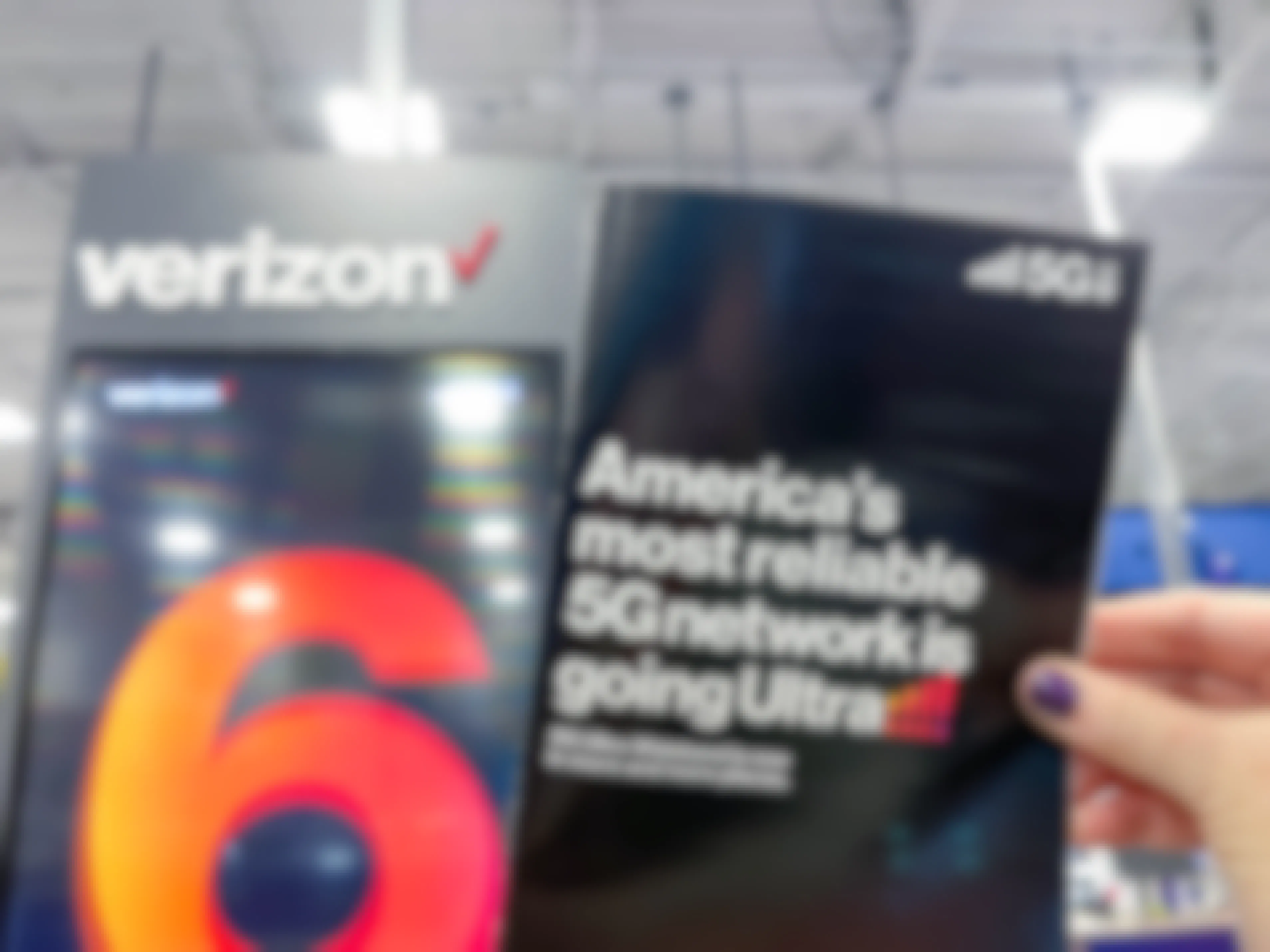 a person holding a verizon flyer in store
