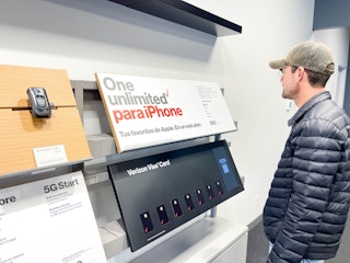 a person looking at a verizon unlimited sign in verizon store