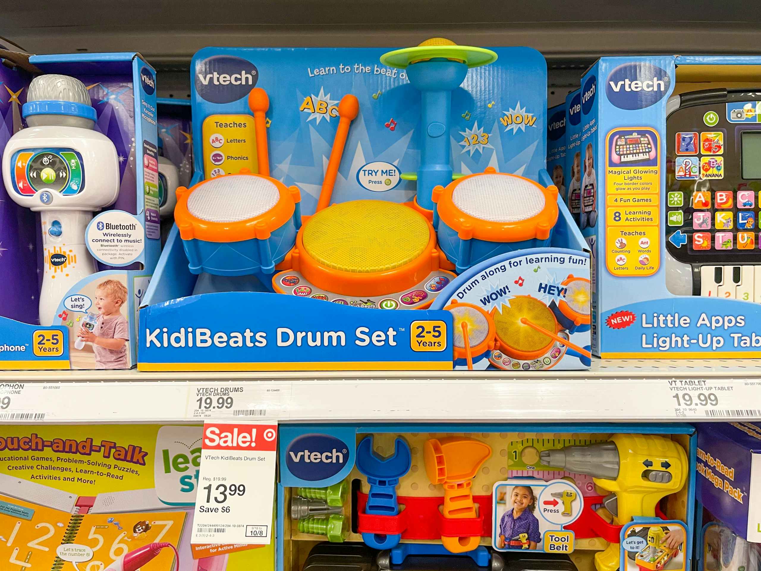 A Vtech drum set sitting on a store shelf