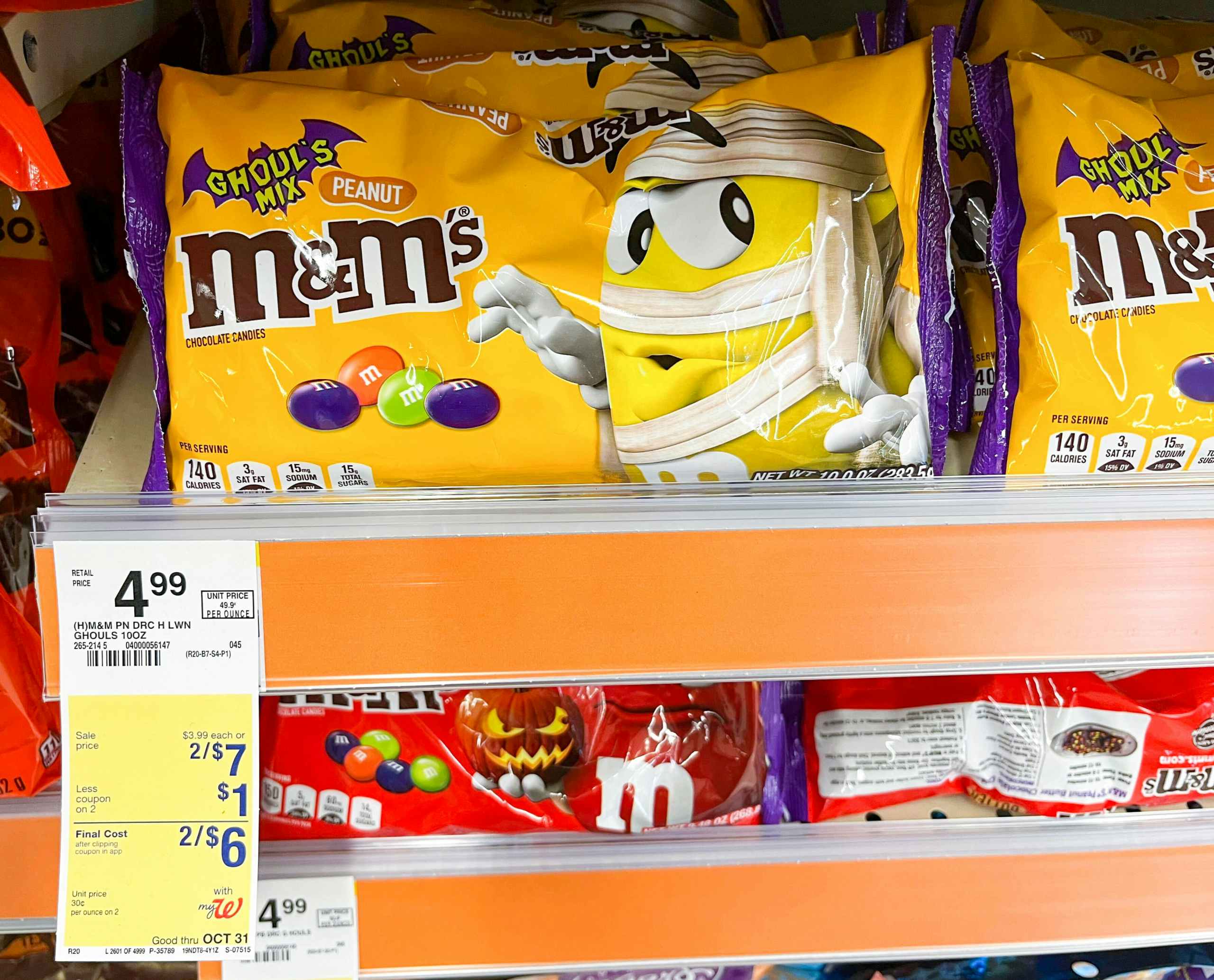 bag of M&M's Ghoul's Mix candy on shelf with sales tag