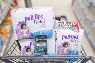 three packs of Pull-Ups New Leaf, M&M's, and a pack of Trojan in shopping cart
