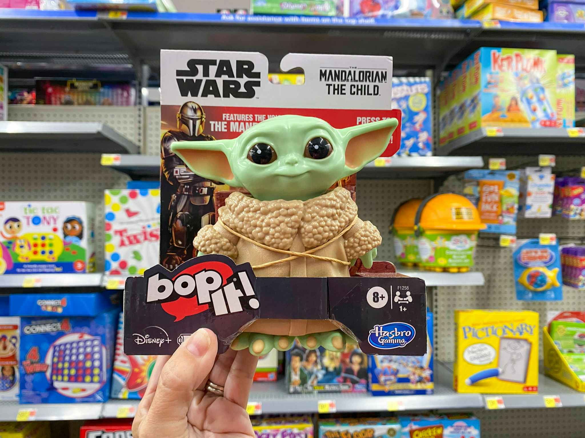 hand holding baby yoda bop it at walmart