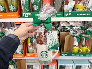 hand holding starbucks mug gift set with hot cocoa mix at walmart