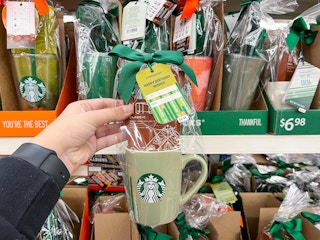hand holding starbucks mug gift set with hot cocoa mix at walmart