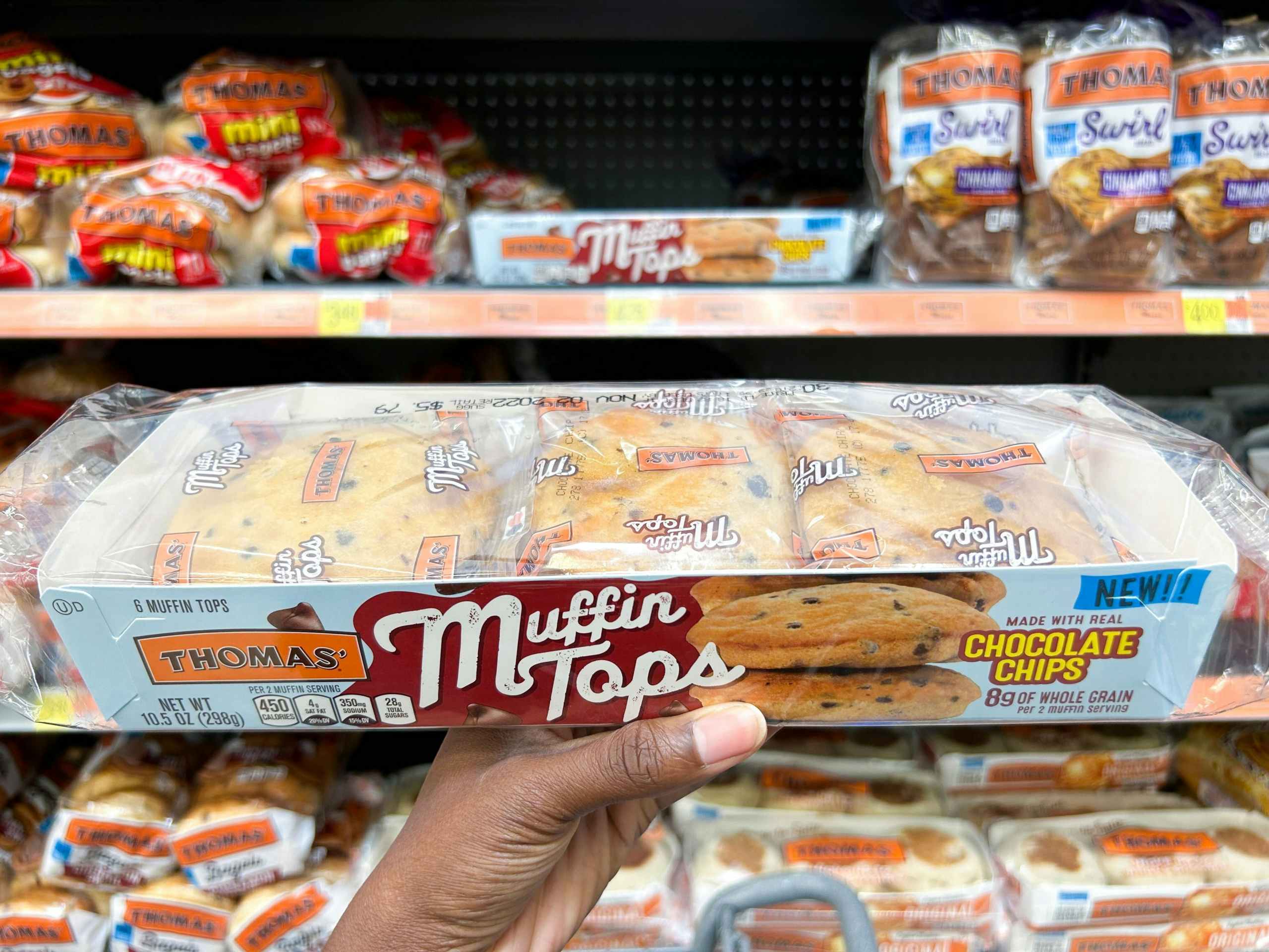 hand holding thomas muffin tops at walmart