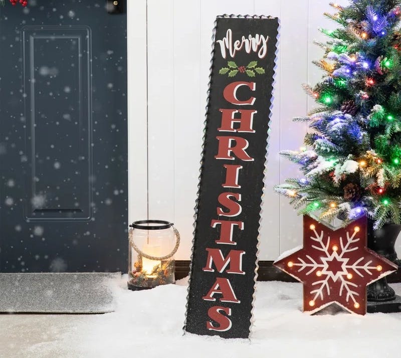 way day christmas decor - A merry christmas sign leaning against the wall on someone's porch
