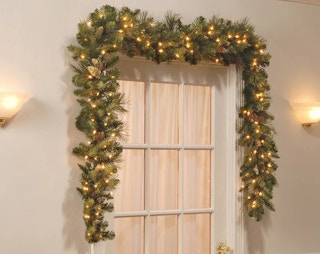 A Ceibhfhionn 108'' Lighted Faux Pinecone Garland above a door