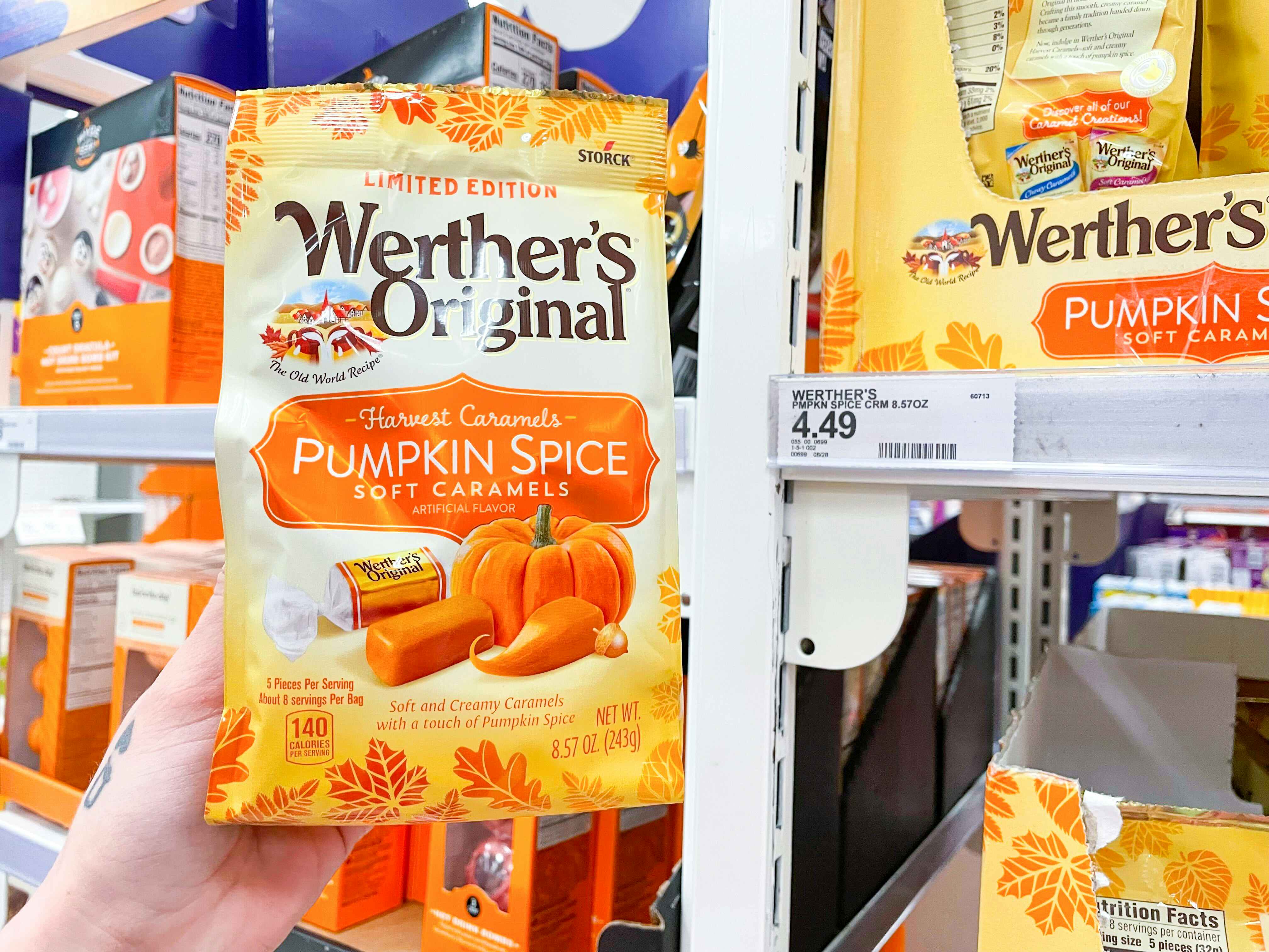 hand holding pumpkin spice caramels next to price tag