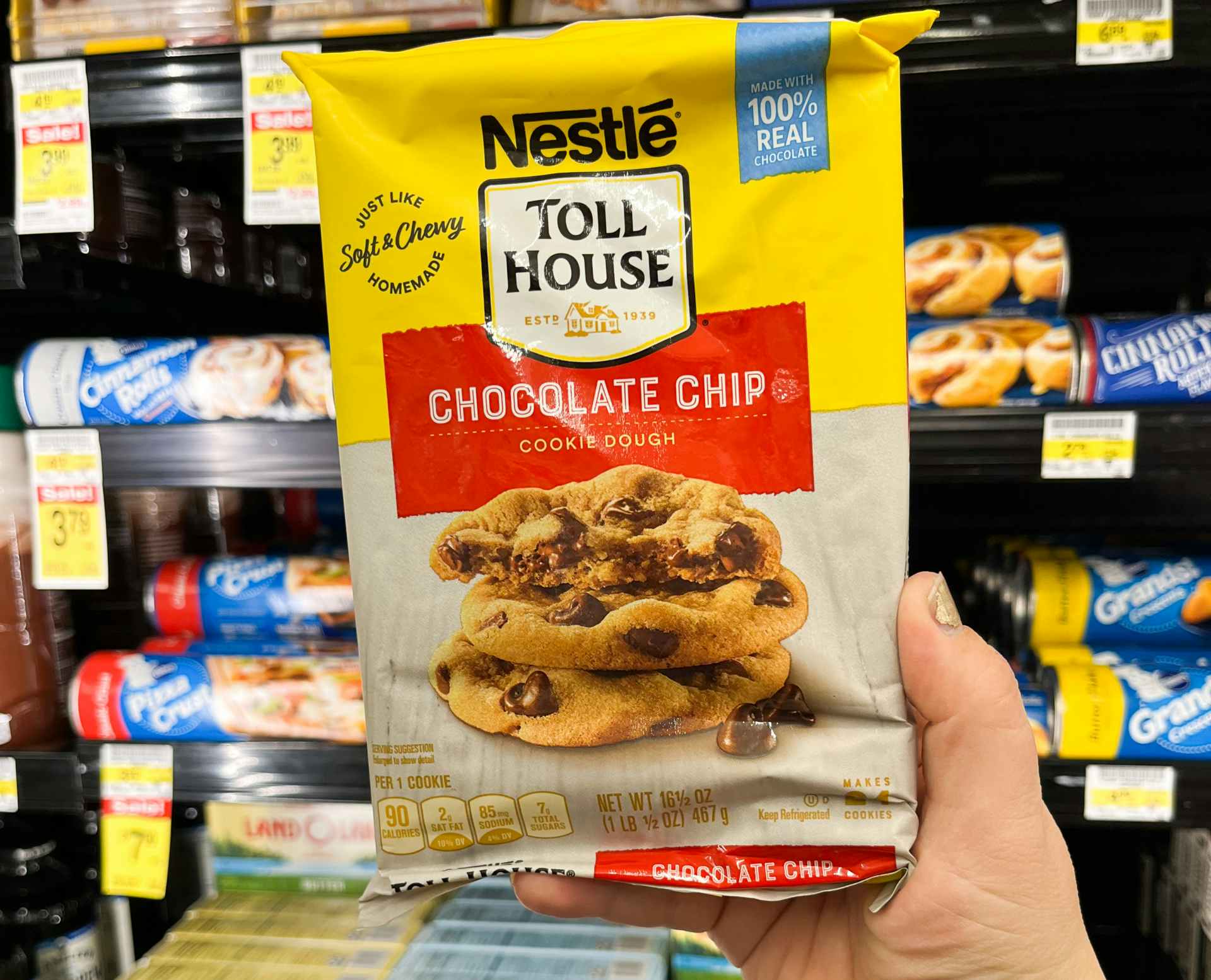 someone holding up a package of Nestle Toll House cookie dough