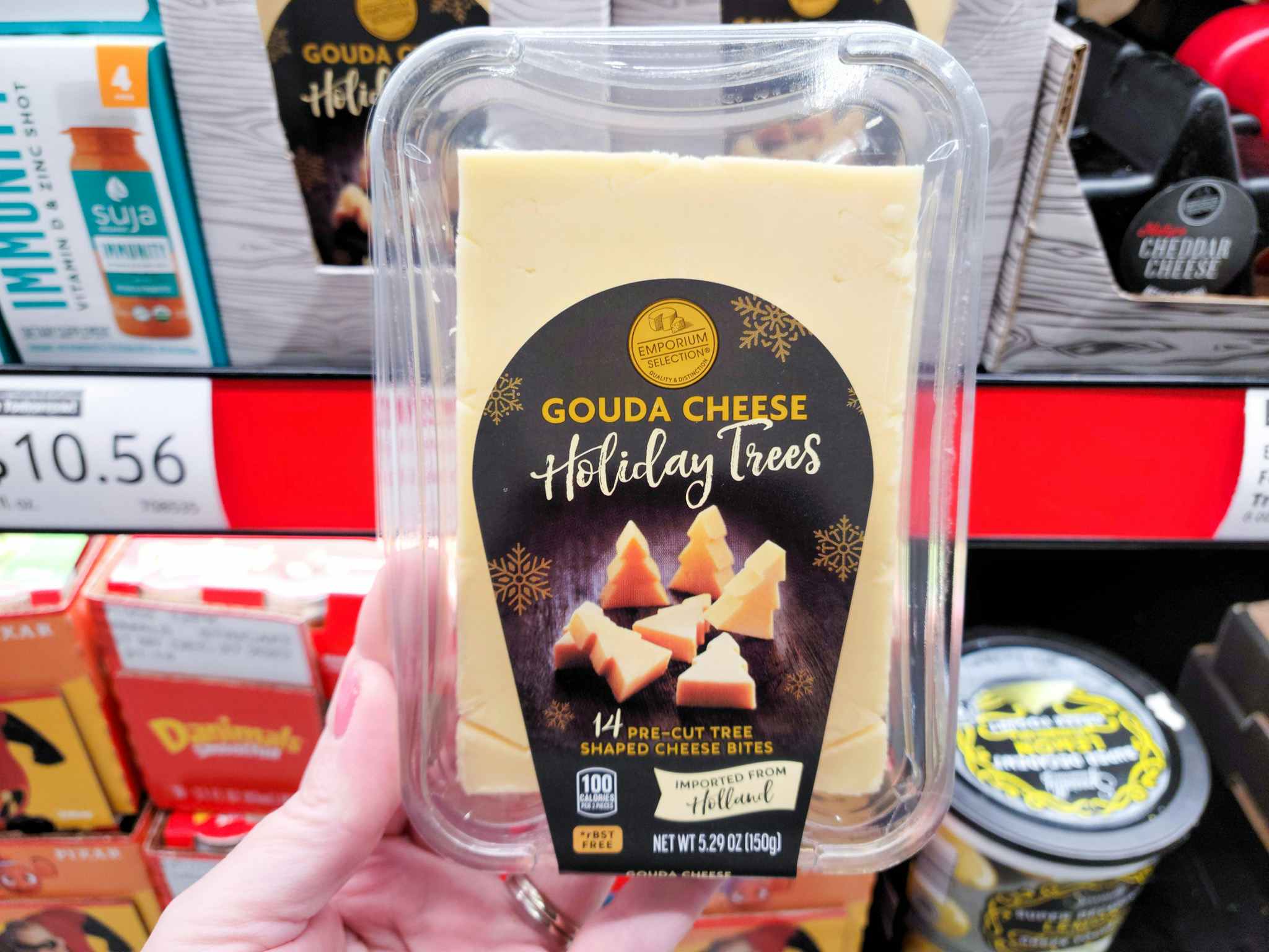 gouda cheese being held in adli store 