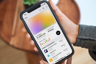 a person holding a cellphone with apple card payment on screen