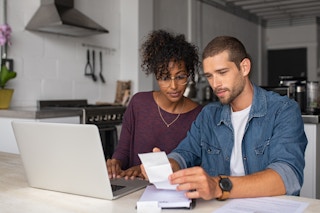 Young couple looking over bills and finances together