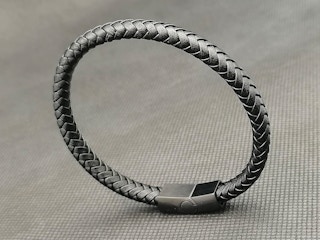 A braided leather bracelet on a table