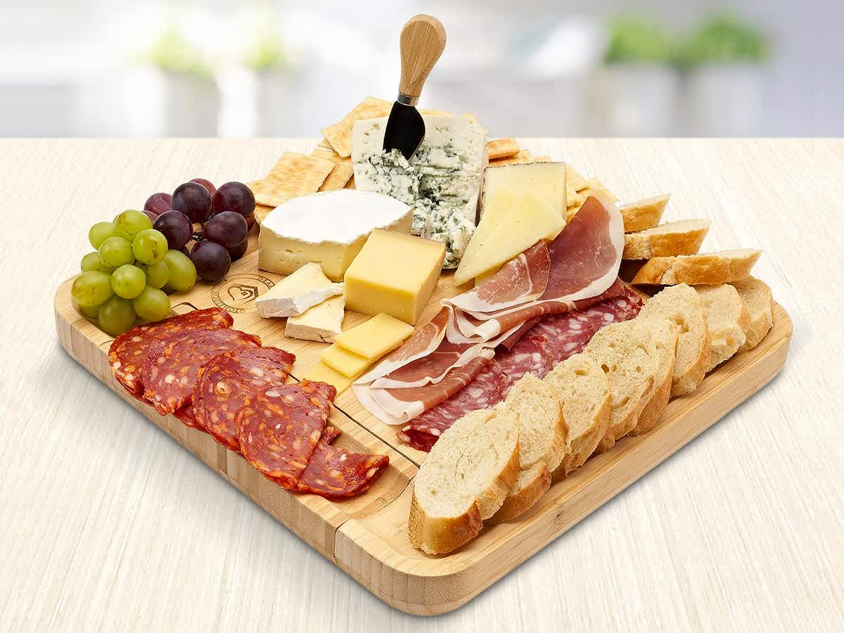 secret santa gifts - A bamboo charcuterie board filled with snacks