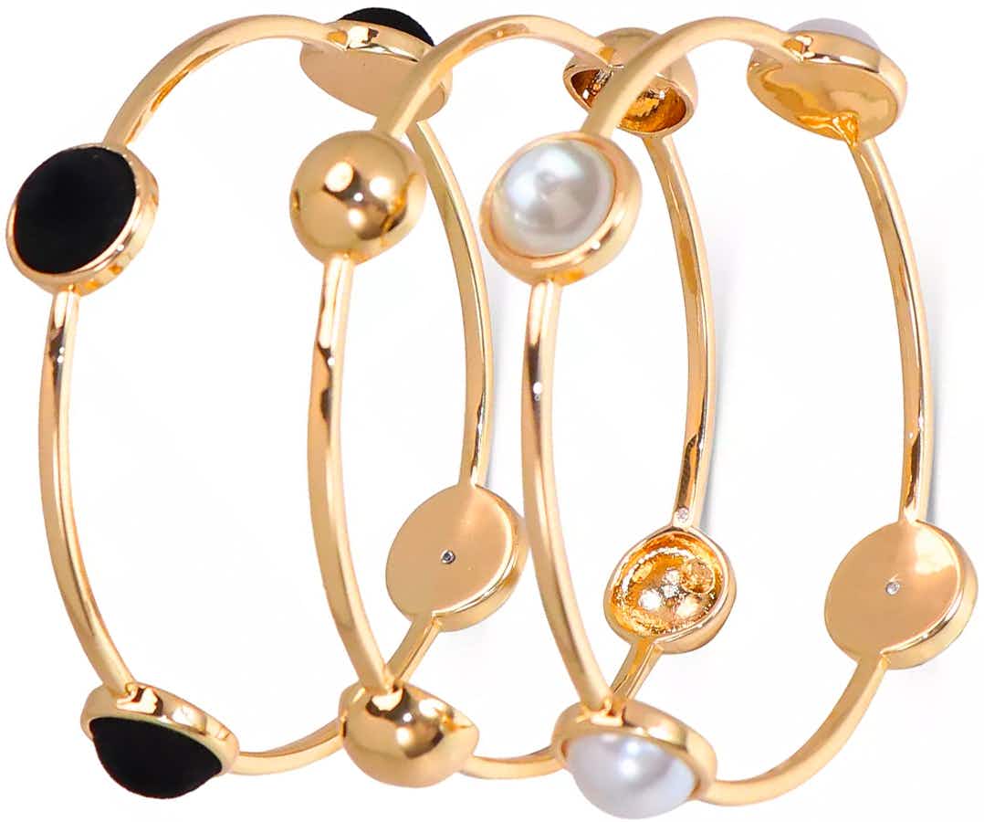 Three gold bangle bracelets with some shiny stones