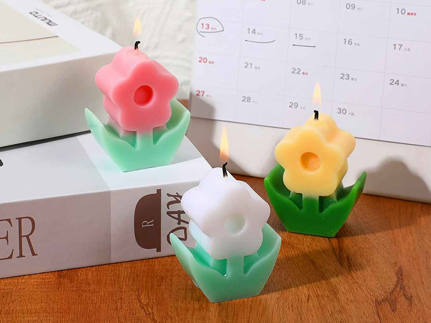 best stocking stuffer ideas - Three flower shaped candles with their wicks lit