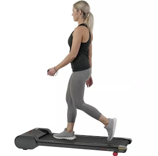 A person walking on a Sunny Health and Fitness Walk Station 