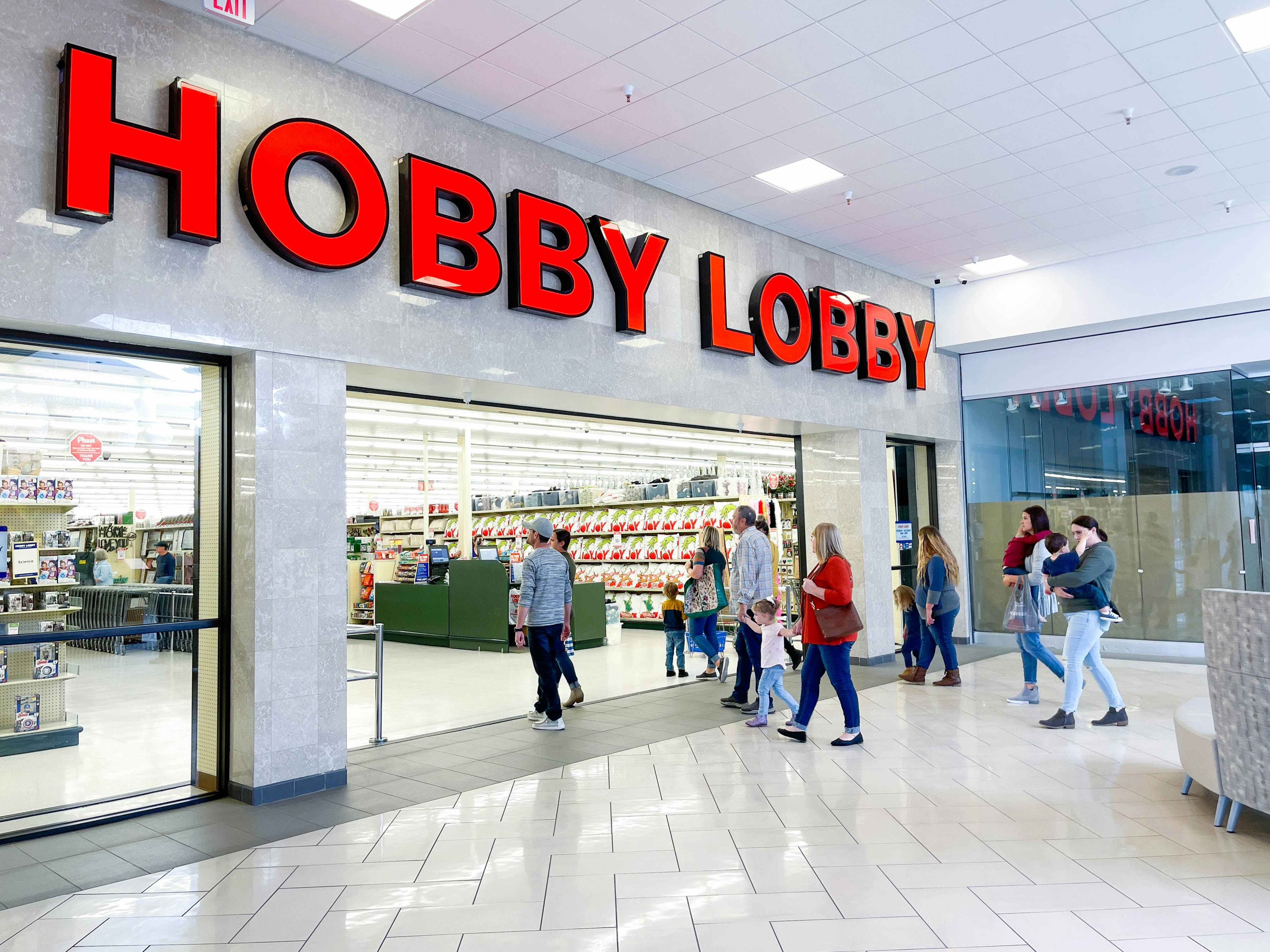 a group of people walking into hobby lobby