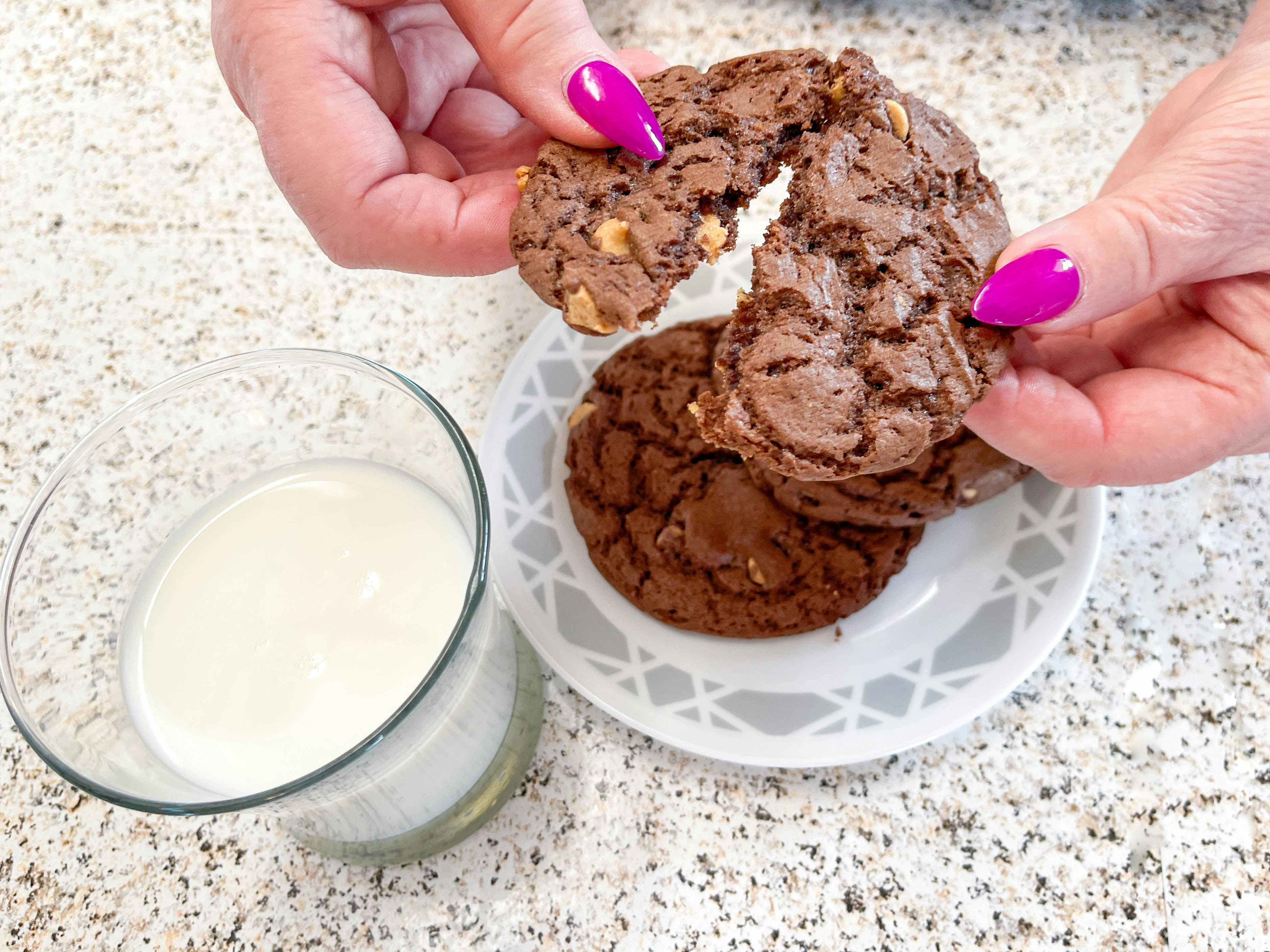 chocolate and peanut butter cookies next to a glass of milk 