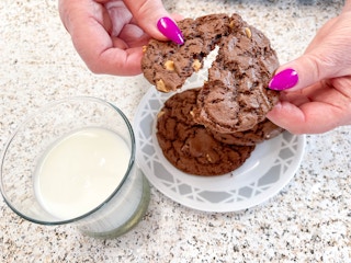 chocolate and peanut butter cookies next to a glass of milk