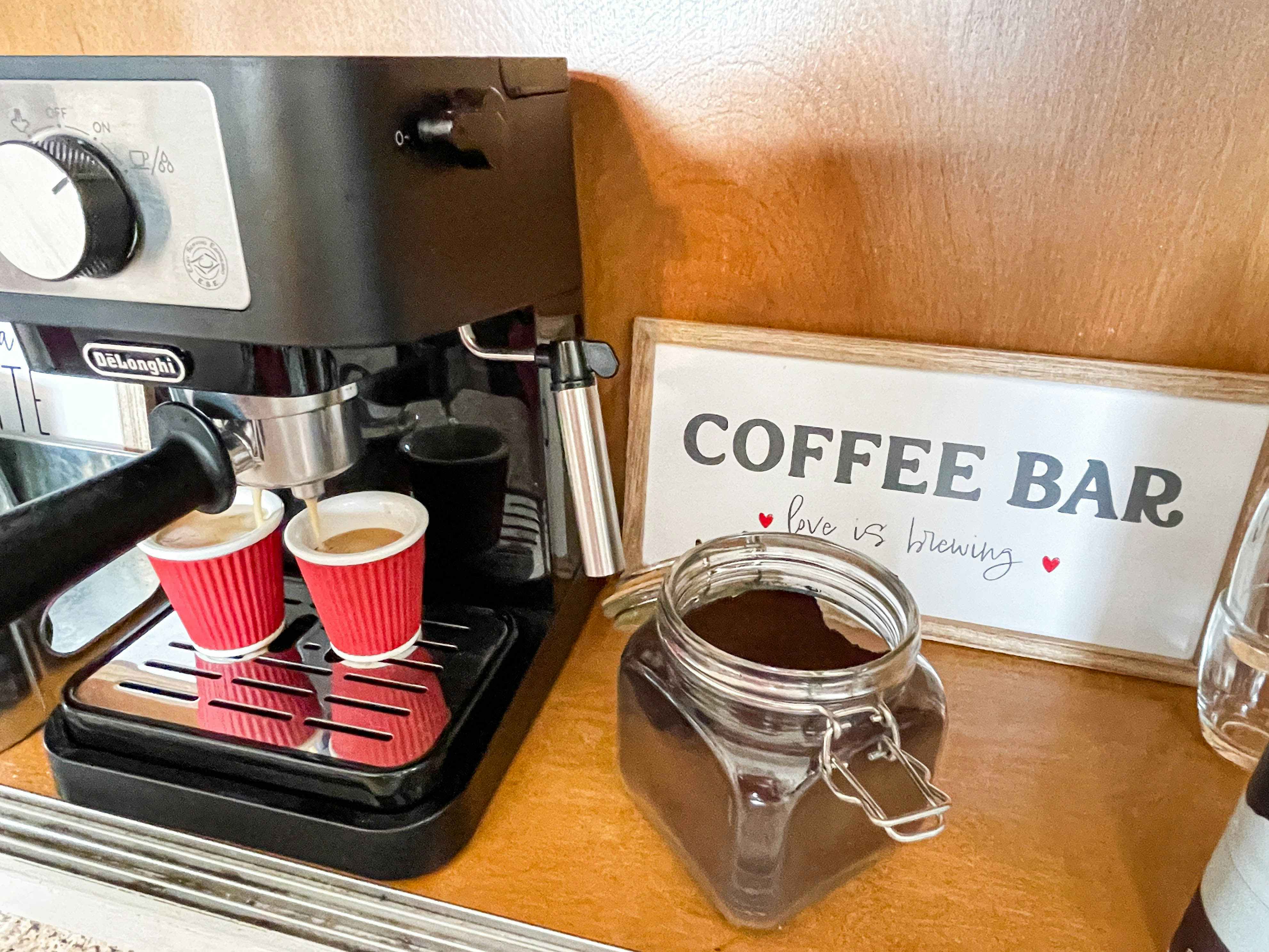 an expresso maker brewing coffee at a home coffee bar 
