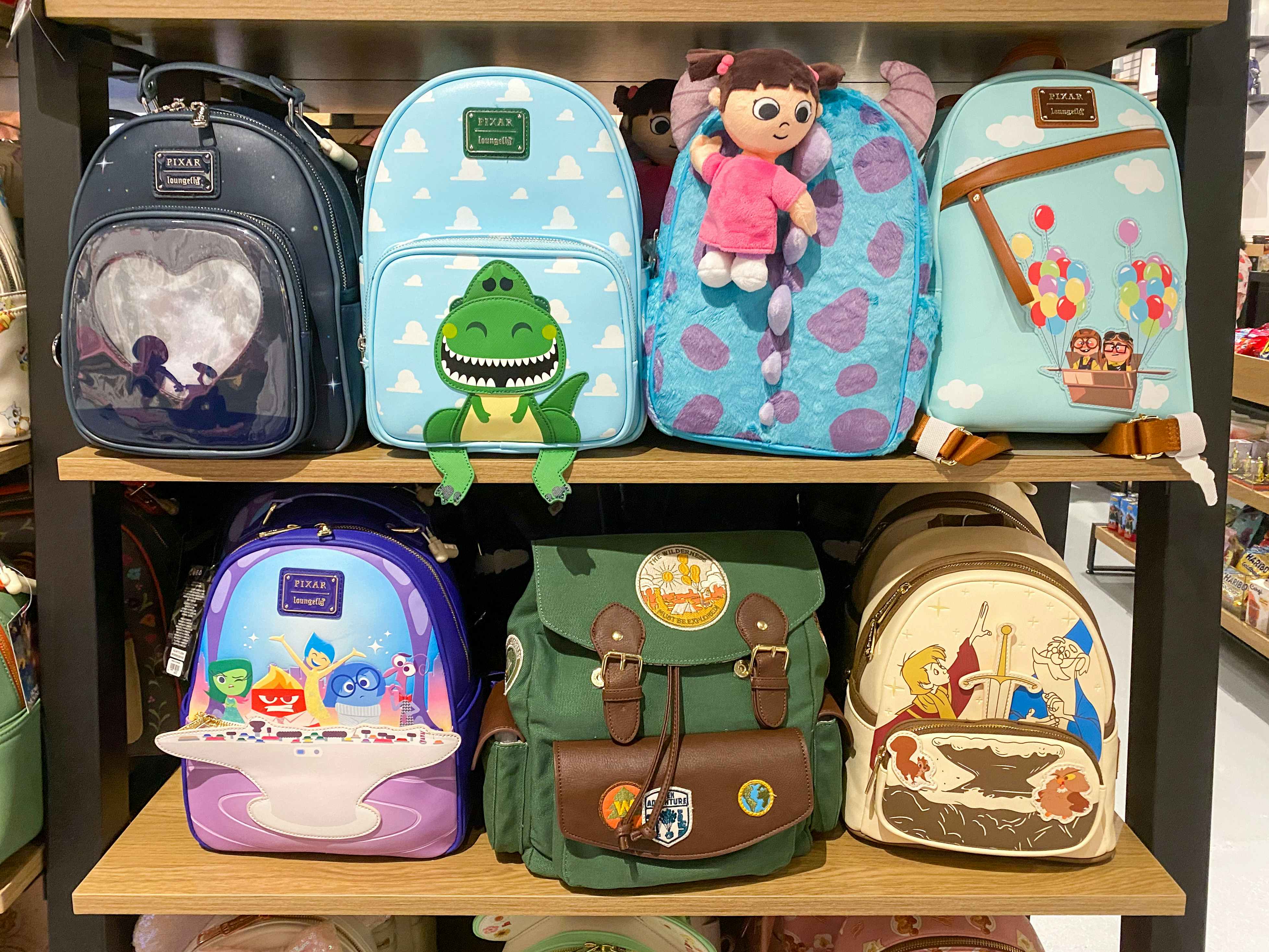 Disney, Loungefly, and other backpack purses on a shelf at BoxLunch