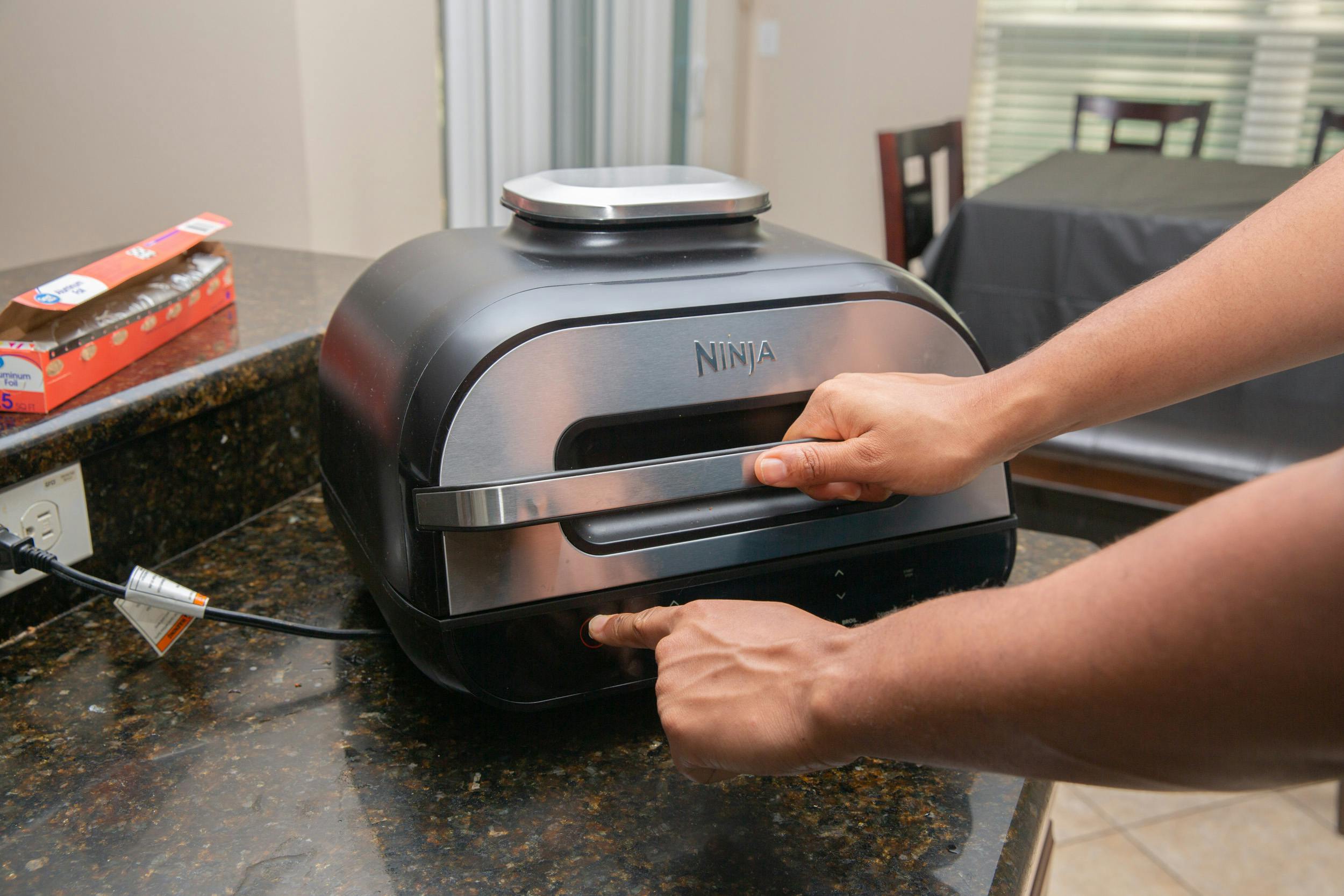 Someone turning on an air fryer