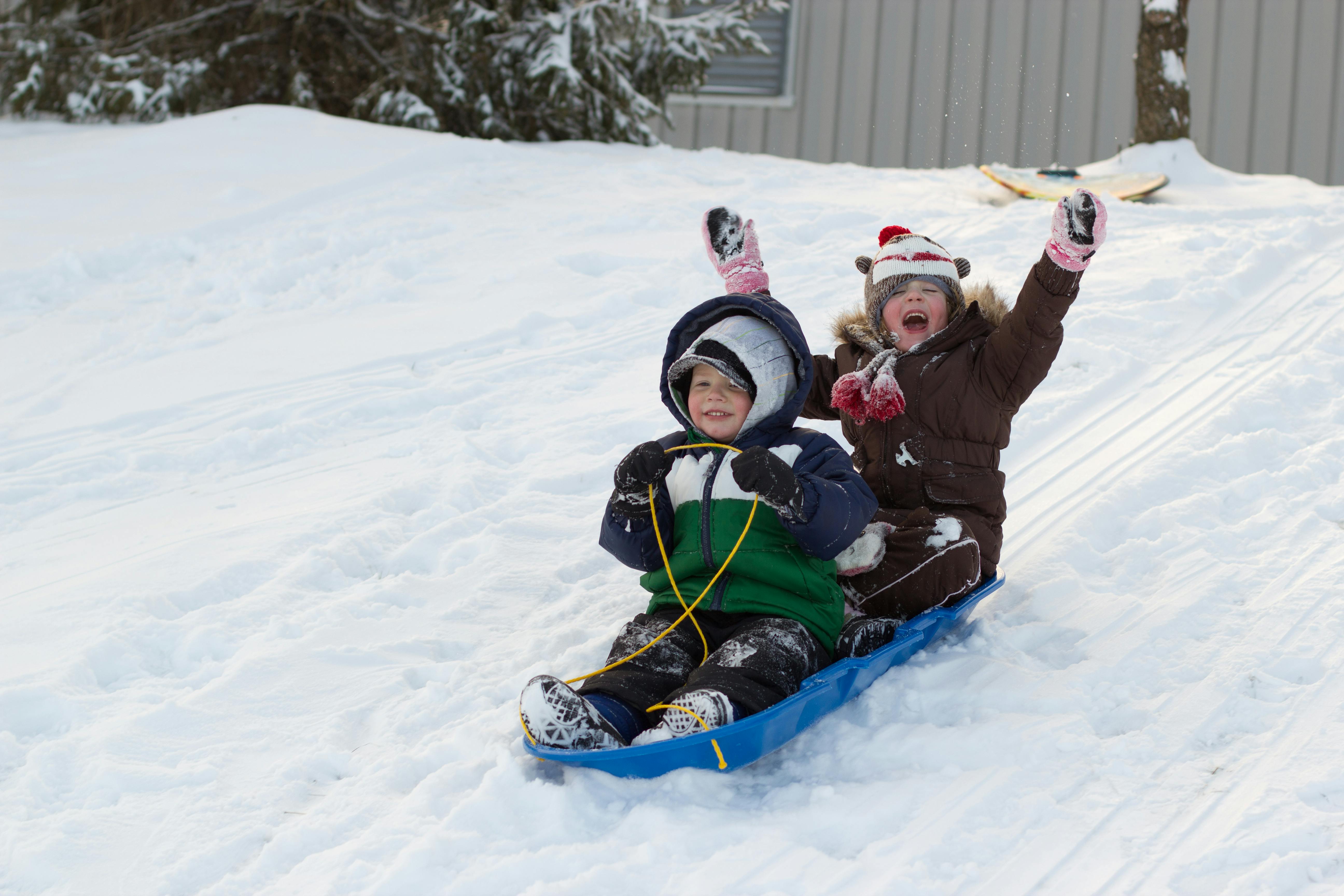 Two children on a snow sled