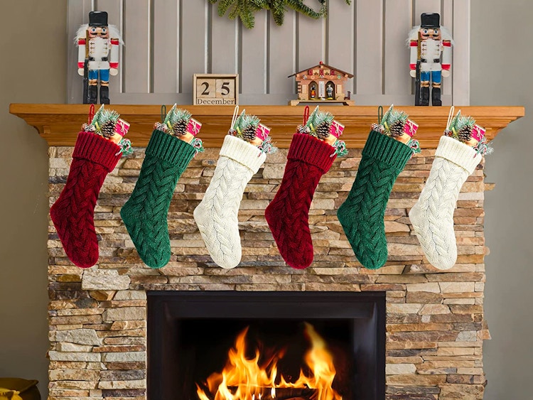 A 6-pack of Kunyida 18-Inch Knitted Christmas Stockings hanging above a fireplace