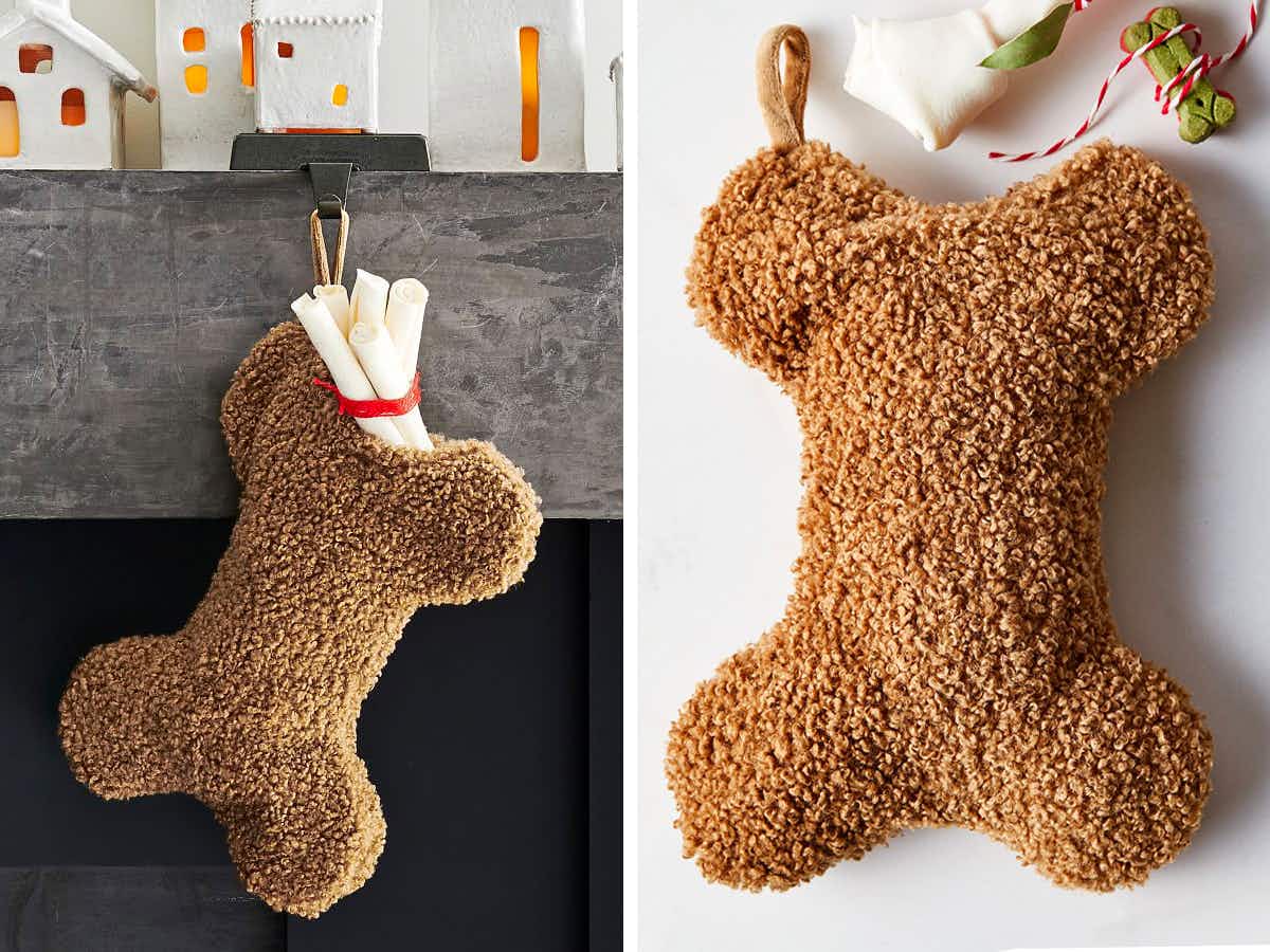 best christmas stockings - A Cozy Teddy Faux Fur Dog Stocking shaped like a bone, hanging from a mantel and on a grey background