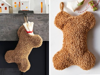 best christmas stockings - A Cozy Teddy Faux Fur Dog Stocking shaped like a bone, hanging from a mantel and on a grey background