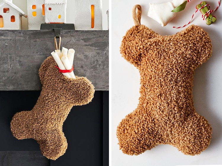 best christmas stockings - A Cozy Teddy Faux Fur Dog Stocking shaped like a bone, hanging from a mantel and on a grey background