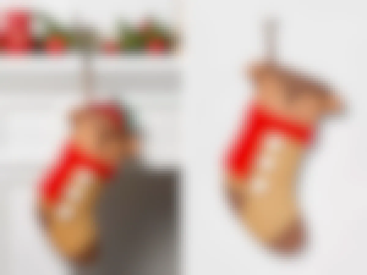 A Wondershop Reindeer Character Christmas Stocking hanging from a mantel and on a grey background