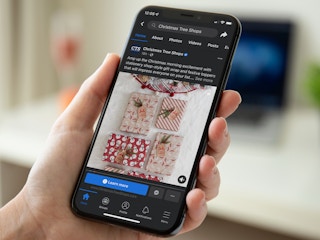Someone looking at the Christmas Tree Shops Facebook page on their phone