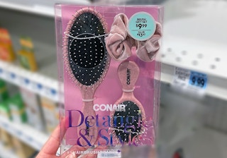 hand holding a conair hair brush gift set