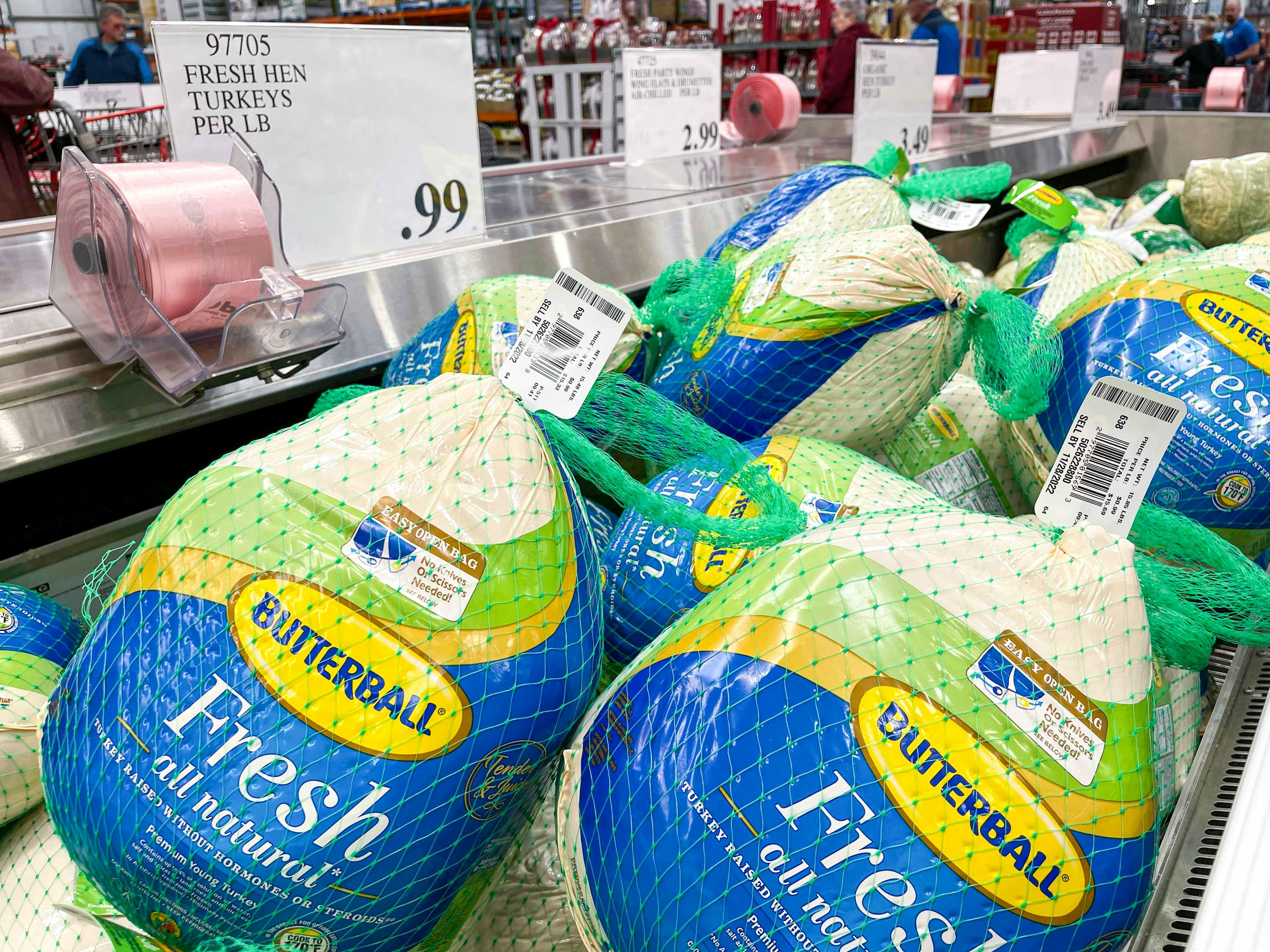 Whole Fresh Butterball turkeys in the refrigerated meat section of Costco with a sign showing them to be 99 cents per pound