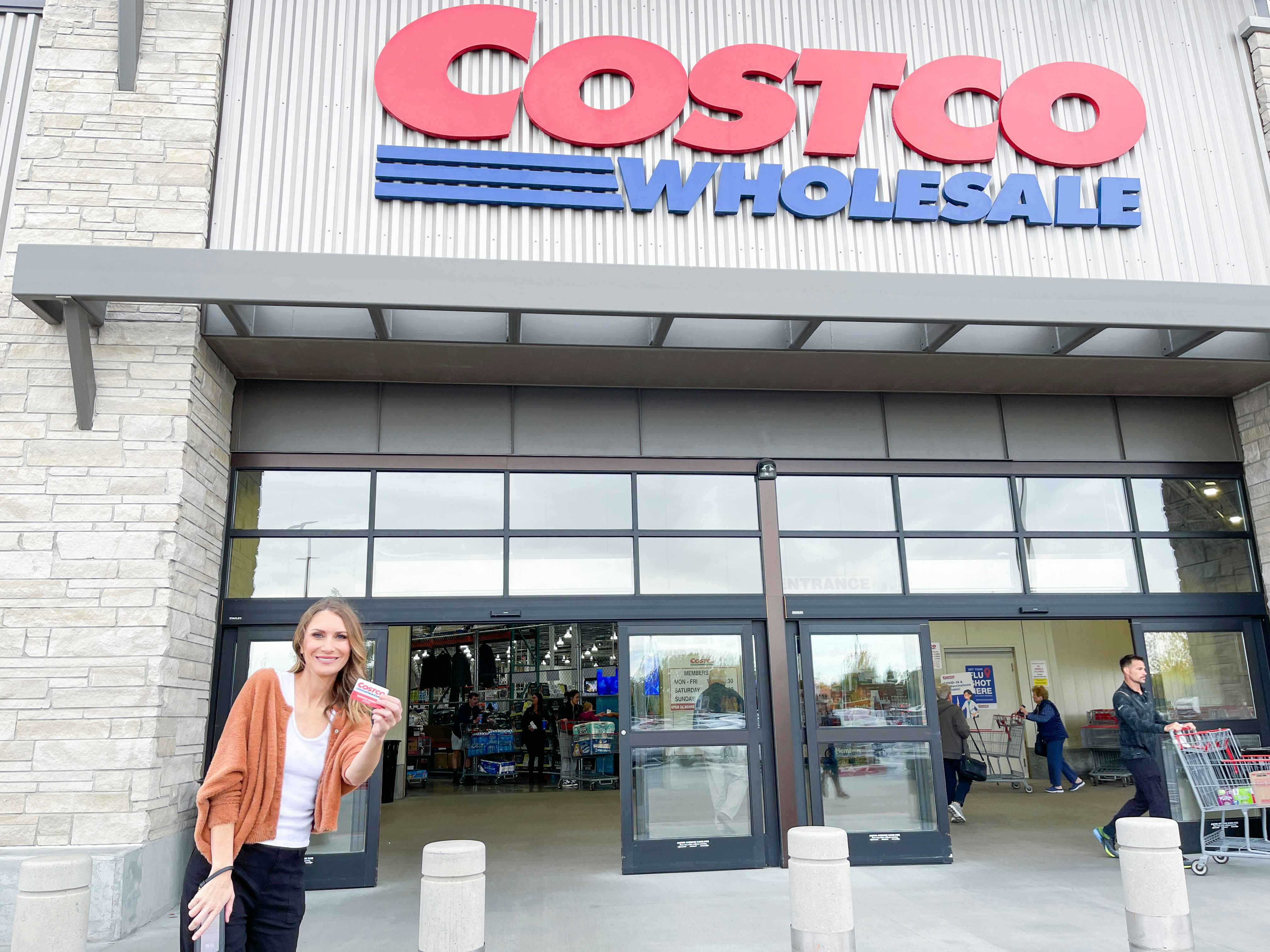 person in front of the costco store sign
