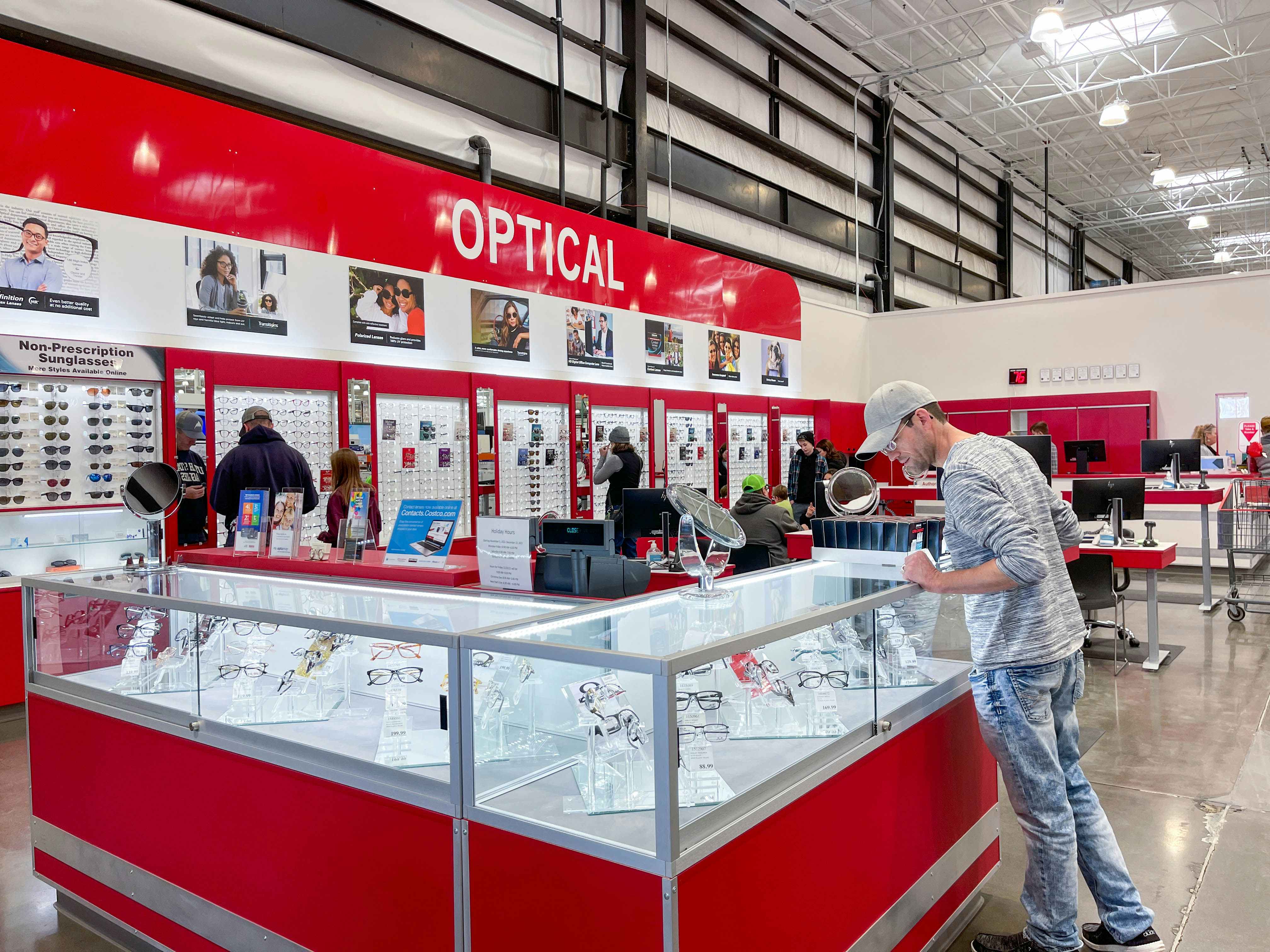 a man looking at costco optical eyeglasses in case