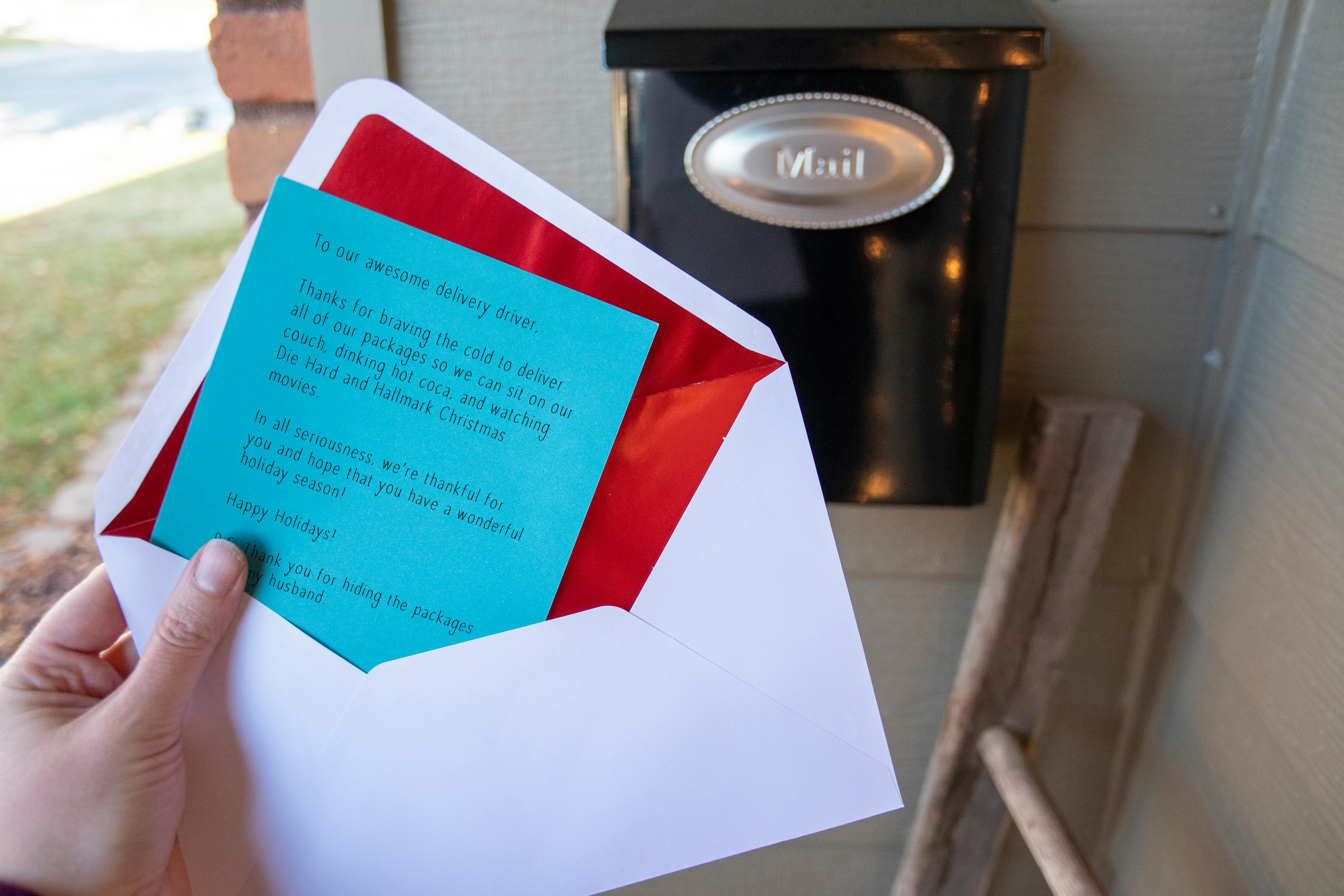 A thank you note held next to a mail box.