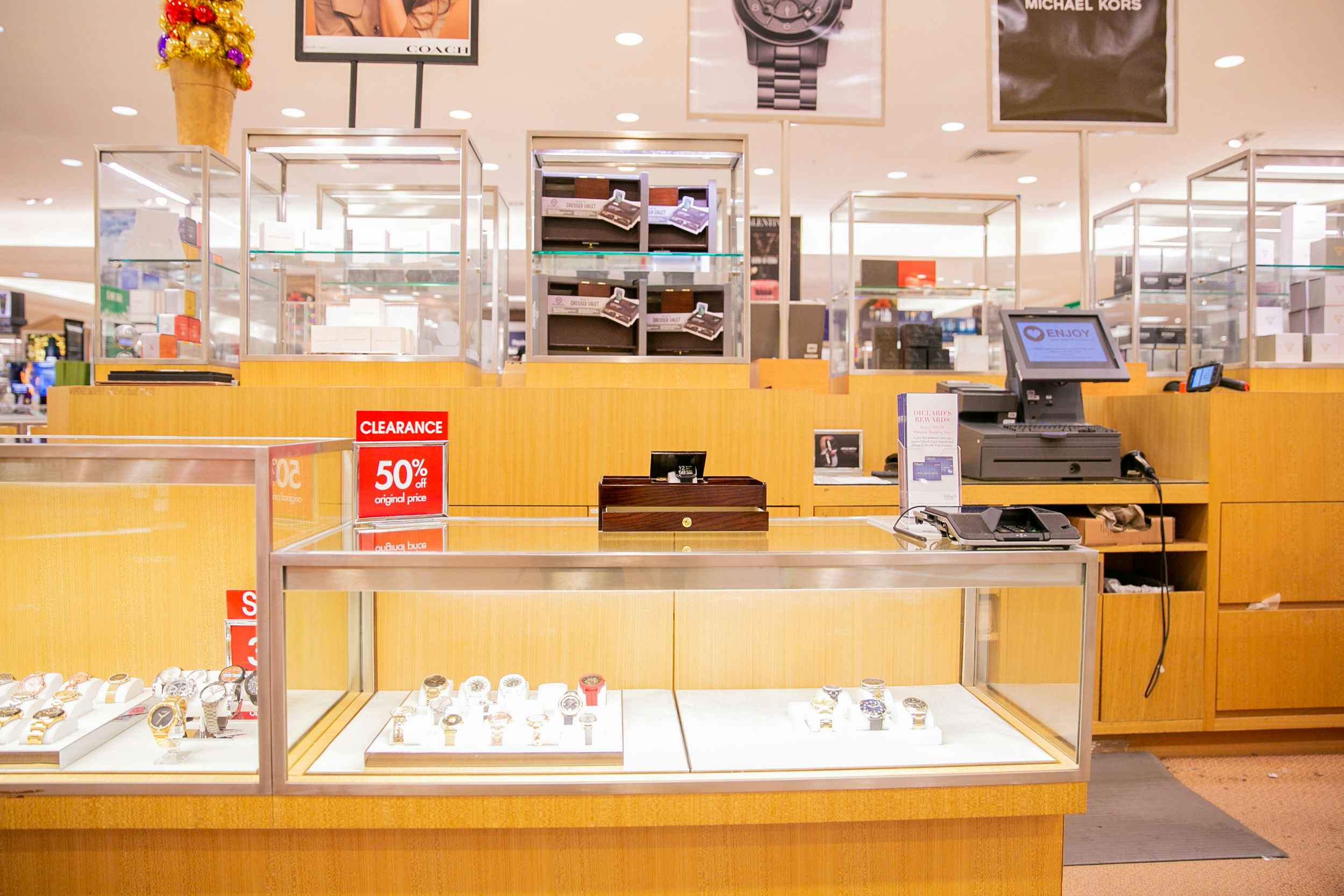Watch counter at Dillards with a red discounted sign 