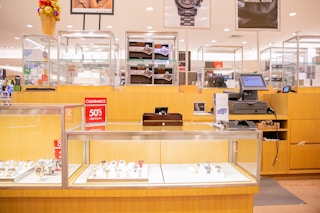 Watch counter at Dillards with a red discounted sign 
