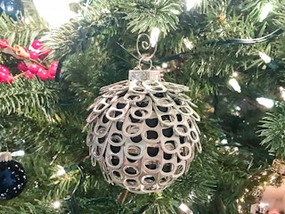 Ornament ball with pop can tabs glued on.