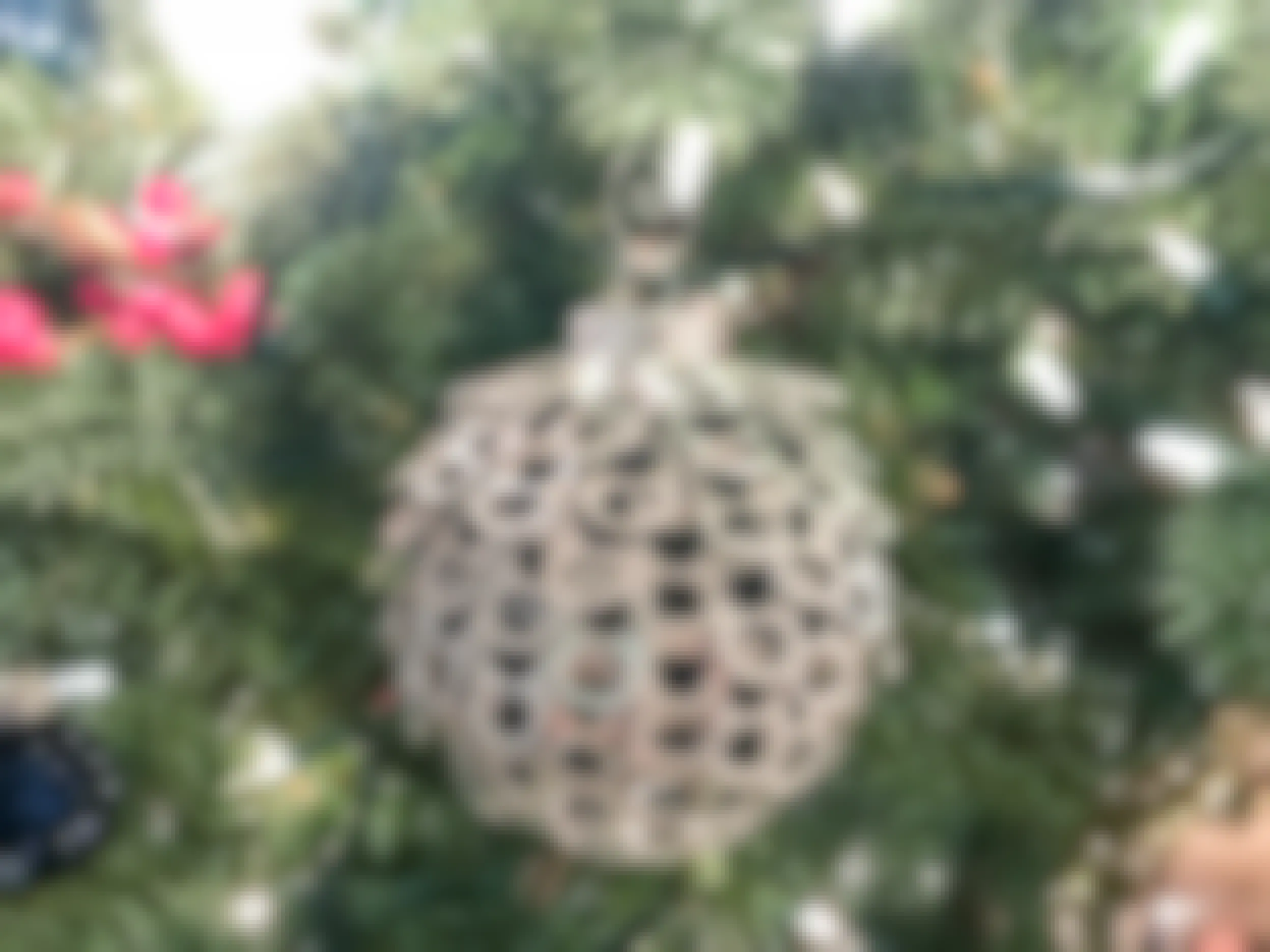 Ornament ball with pop can tabs glued on.