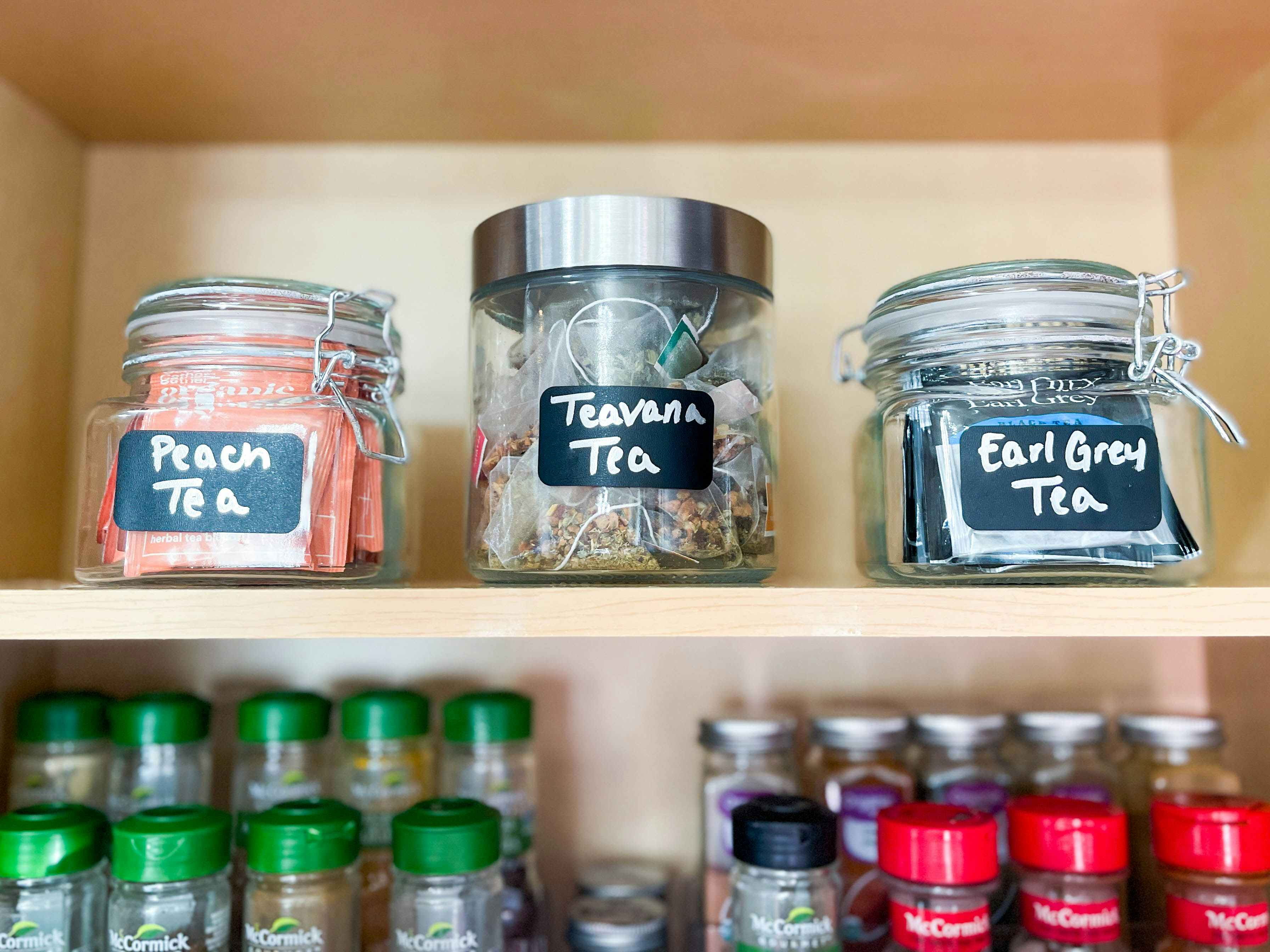 jars labeled and filled with tea on a shelf 