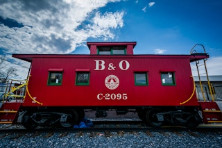 B and O Red Train Car against a clear blue sky
