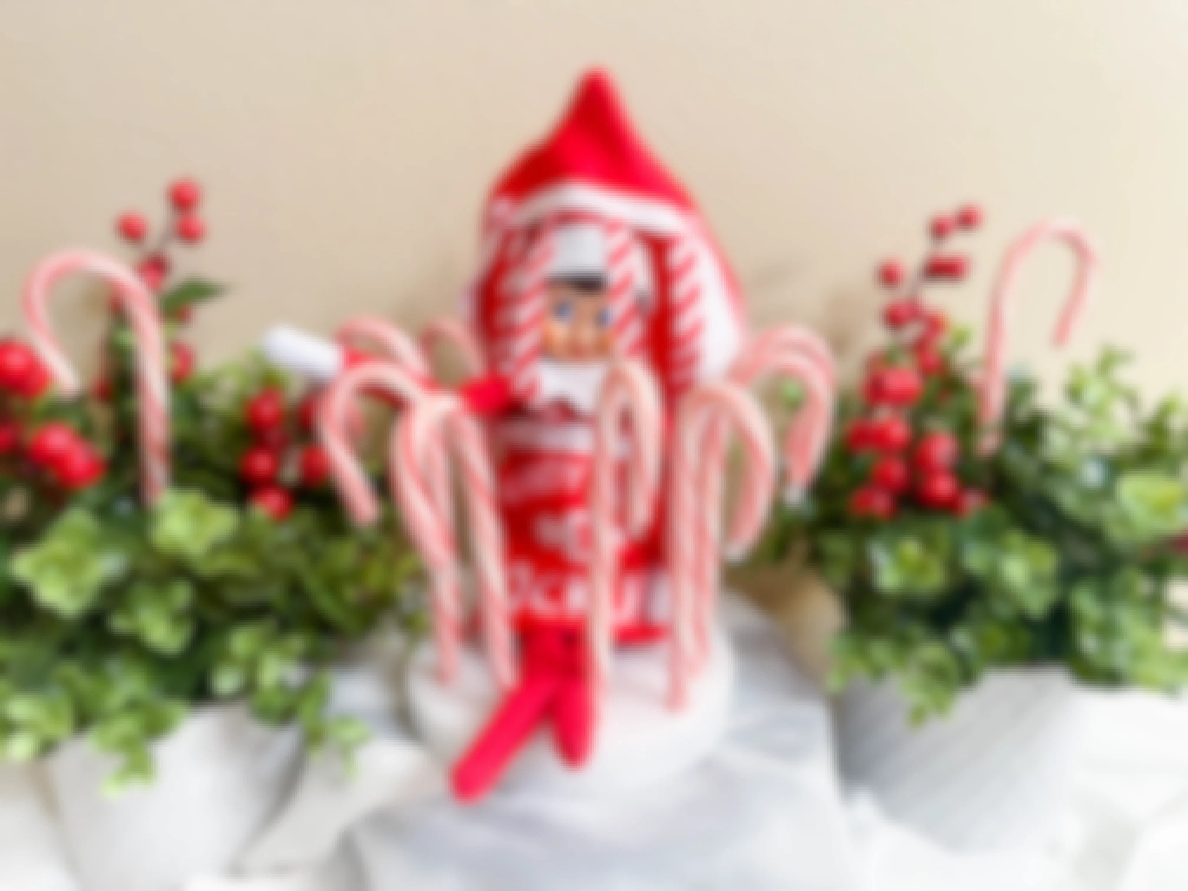 elf on the shelf doll in costume in diy candy cane jail 