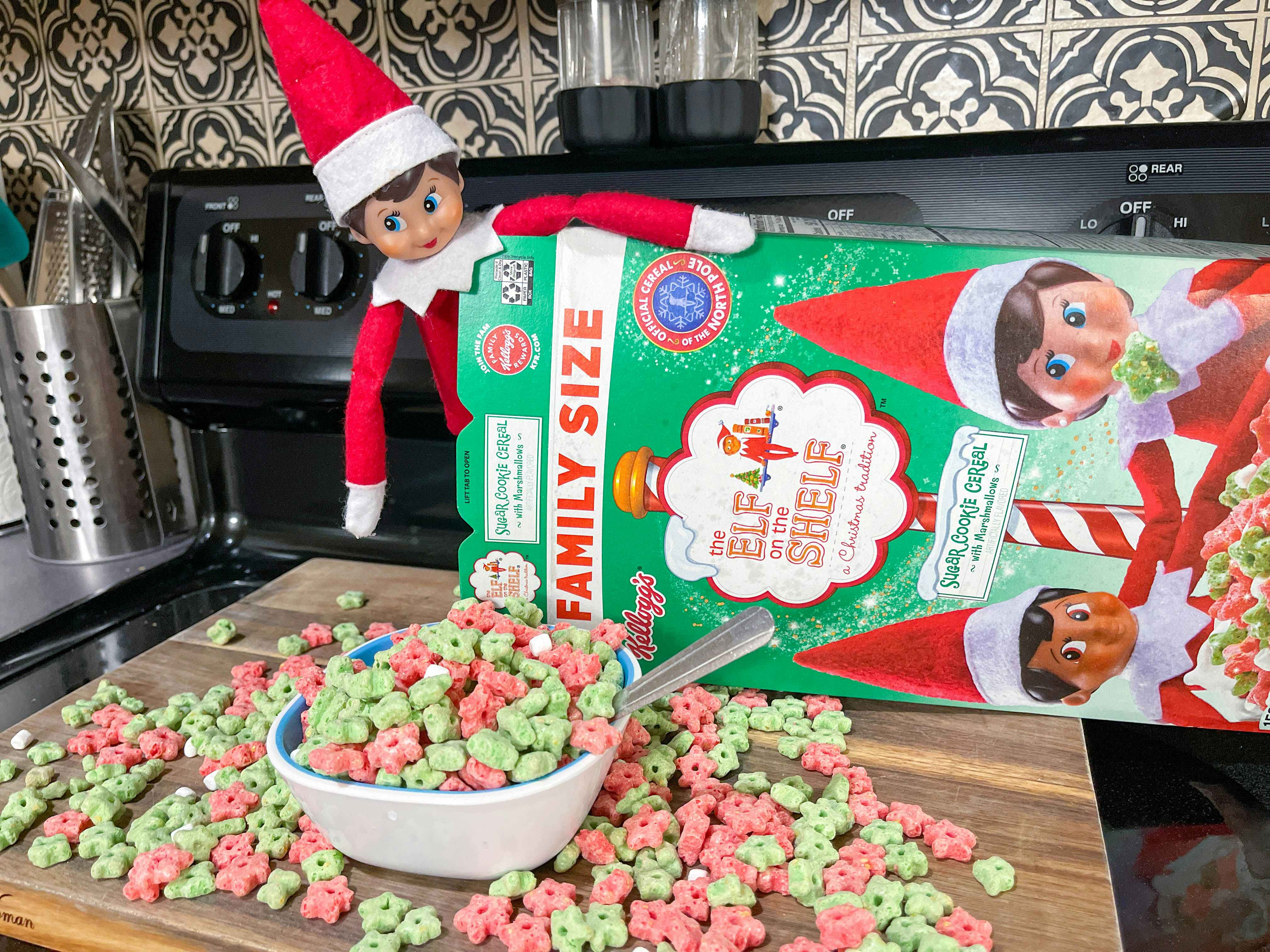 elf on the shelf doll inside a cereal box in front of a full bowl 